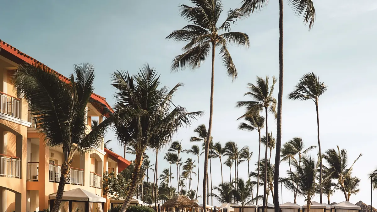 Resort pool framed by palm trees