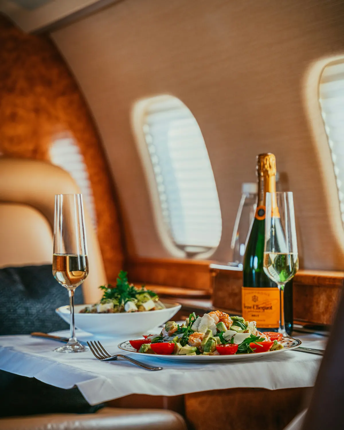 Glasses of champagne raised over a set table